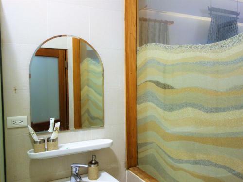 a bathroom with a sink and a mirror at Ocean Sky B&B in Huxi