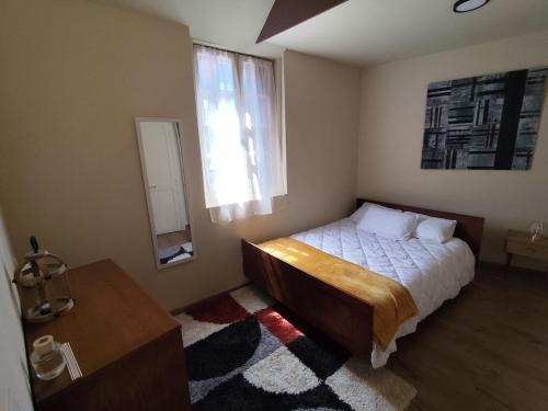 a bedroom with a bed and a window at Authentique Maison de Pêcheur Le Refuge in Le Tréport