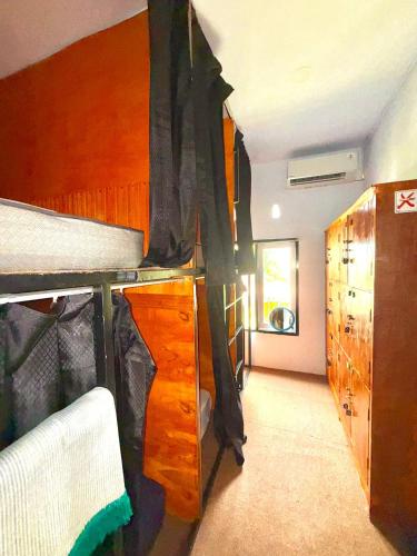 a bedroom with a bunk bed and a dresser at ak Hostel selayar in Benteng