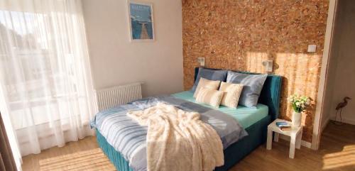 a bedroom with a bed with blue sheets and pillows at Mazurski relax plus Taras Garaż podziemny in Węgorzewo