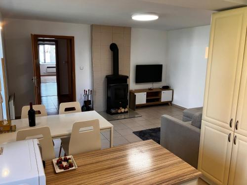 a living room with a table and a fireplace at Chalupa Marie in Radimovice u Želcě