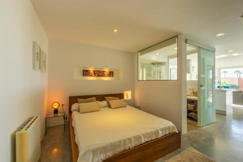 a bedroom with a bed and a large mirror at Caracolas Luxury House in Tarifa
