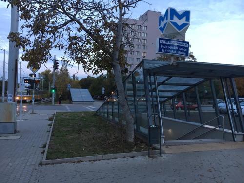 a bus stop with a sign on top of it at Airport Apartment in Sofia