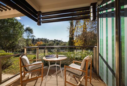 a patio with a table and chairs on a balcony at Monte Mulini Adults Exclusive Hotel by Maistra Collection in Rovinj