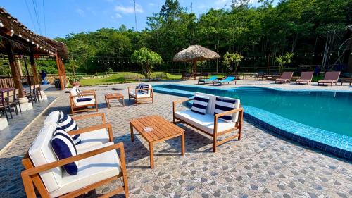 a group of chairs and tables next to a swimming pool at Loop Tribe - Social Hostel in Ha Giang
