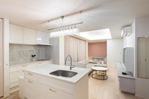 a kitchen with white cabinets and a sink at RHUMB LINE Tokyo in Tokyo