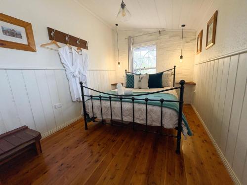 a bedroom with a bed in the corner of a room at Gladstone House in Beechworth