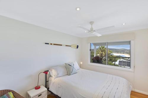 a white bedroom with a bed and a window at Copa Dell - Stunning Views in Copacabana