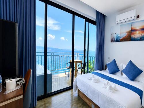 a bedroom with a bed and a view of the ocean at The Cliff Bungalow in Koh Rong Sanloem