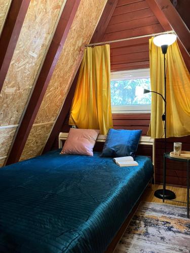 a bedroom with a bed in a attic at Ostoja Lipiny in Sompolno