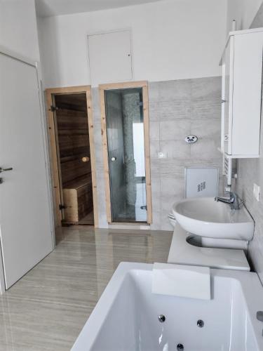 a white bathroom with a sink and a toilet at La Marina Rooms HOWME in Torre a Mare