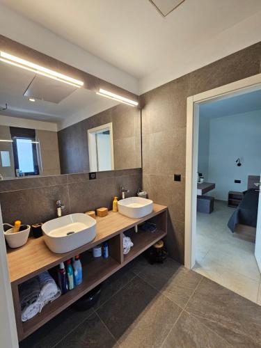 a bathroom with two sinks and a large mirror at Vila Dora with Private Pool in Radetići