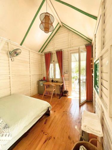 a bedroom with a bed and a desk in it at Phan rang kite center in Ấp Mỹ Hải