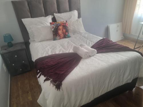 a bed with a doll sitting on top of it at Melos Cosy Retreat in Ezulwini