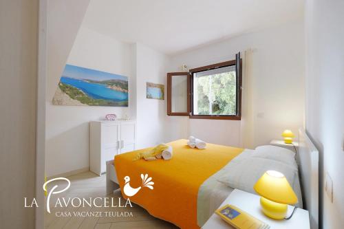a bedroom with a yellow bed and a window at Case Vacanze La Pavoncella in Teulada