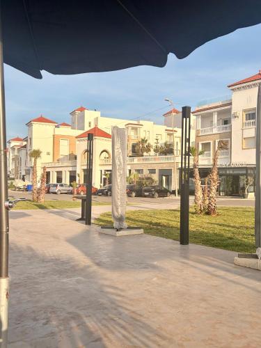 a group of sculptures on a sidewalk in a city at Al Hoceima Hay Bades Villa in Al Hoceïma
