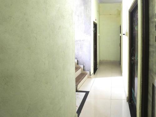 an empty hallway with stairs in an empty room at Hotel O Celebrity in Chandrapur