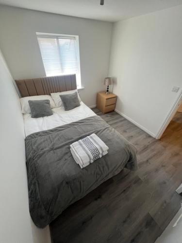 a bedroom with a large bed and a window at Favour homes in Manchester