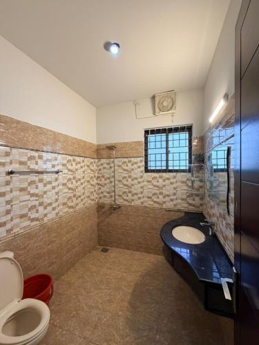 a bathroom with a toilet and a sink at Grand Residency Guest House in Islamabad