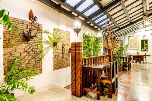 a large room with plants on the walls at Palm Mansion Boutique Suites in George Town