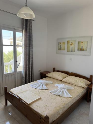a bedroom with a bed with two towels on it at Nikos Apartments in Lefkos Karpathou