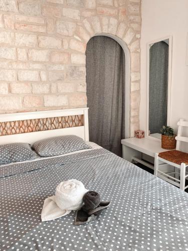 a bedroom with a bed with a hat on it at Central Parikia stay-Helios in Parikia