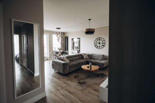 a living room with a couch and a table at Apartament Złote Noce in Augustów