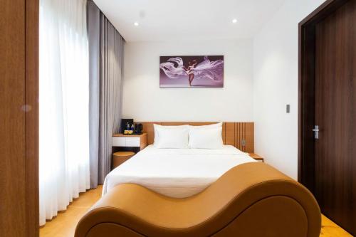 a bedroom with a large bed in a room at Adora Hotel Khe Sanh in Khe Sanh