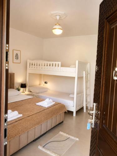 a bedroom with two bunk beds and a door at Guest House Emi in Berat
