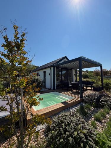 a house with a pool and a gazebo at Lavendream in Kőröshegy