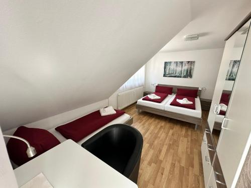 a small room with two beds and a table at Hotel Gasthaus Stern in Nusplingen