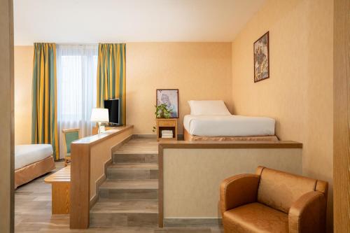 a hotel room with a bed and a chair at Best Western Cavalieri Della Corona in Cardano al Campo