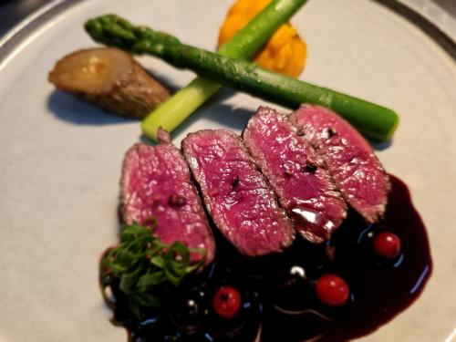 a plate of food with meat and vegetables on it at Locanda Furanora in Furano