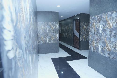 a hallway with paintings on the walls of a building at V Rooms in Pendurti