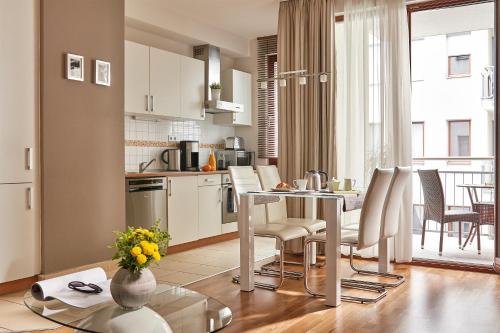 a kitchen and living room with a table and chairs at 7Seasons Apartments Budapest in Budapest