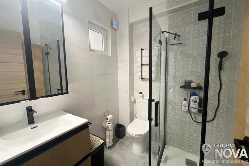 a bathroom with a shower and a toilet and a sink at Marina Tavernes in Tavernes de Valldigna