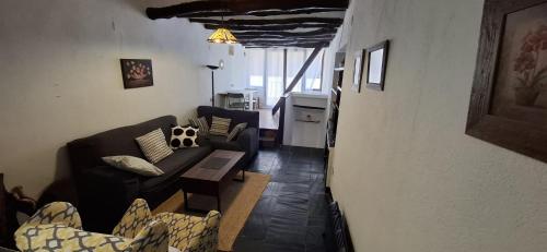 a living room with a couch and a table at Casa Pura de Trevélez in Trevélez