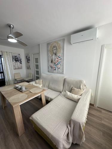a living room with a couch and a table at apartamento peñon de jolucar in Torrenueva