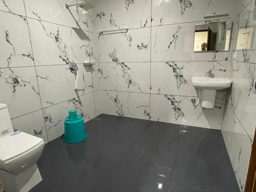 a bathroom with a toilet and a sink at Mahout Resort Wayanad - An Experiential Jungle Stay with Waterfall in Kalpetta