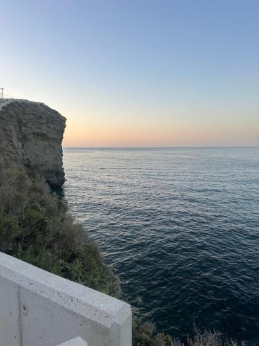 a view of the ocean from a cliff at apartamento peñon de jolucar in Torrenueva
