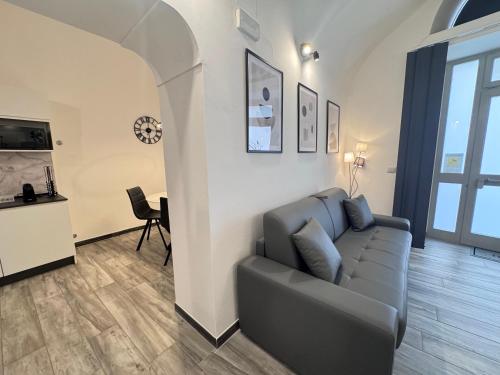 a living room with a couch and a table at Norcia Stylish Apartment in Norcia