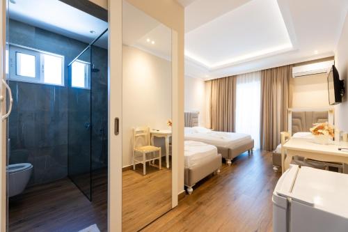 two views of a hotel room with two beds and a bathroom at Hotel Vila Mare in Durrës