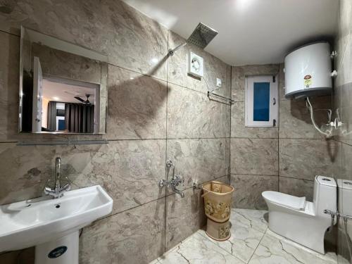 a bathroom with a sink and a toilet at K2 Alpine Hotel in Pahalgām