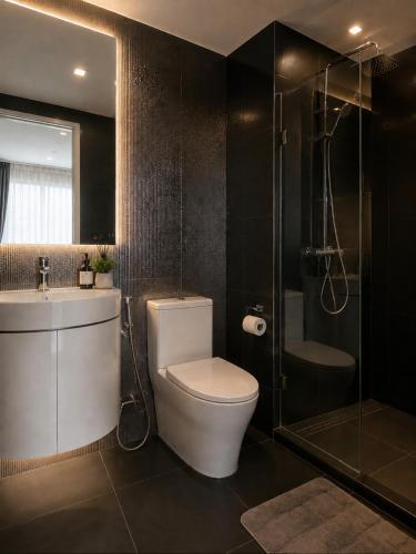 a bathroom with a toilet and a sink and a shower at Ultra luxury Condo in Bangkok