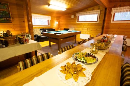 a dining room with a table and a pool table at Kyyronkaita in Mikkeli