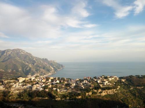 a view of a town on a hill next to the ocean at B&B Oliva in Scala