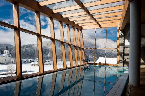 a view of a pool from a building with windows at Bohinj Eco Hotel in Bohinj