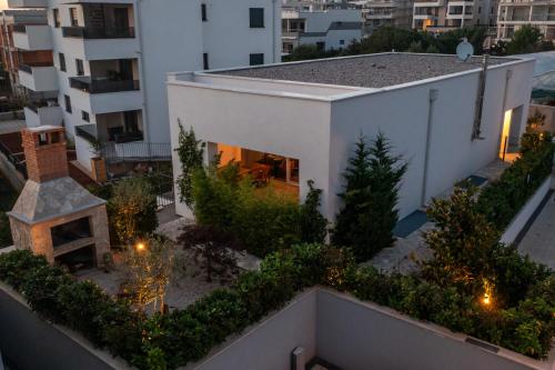 a white house with a garden on top of a building at Zen House in Zadar