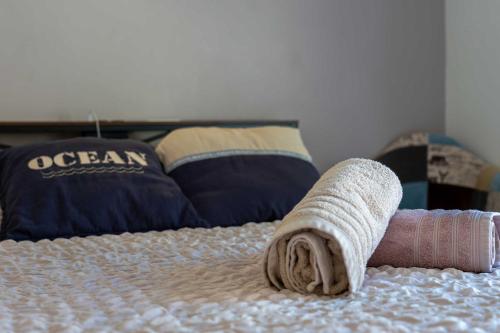 a rolled up towel on top of a bed at AppartHotel le Nid Marin in Aytré