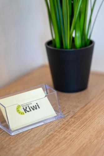 a bar of kiwi soap on a table next to a plant at AppartHotel le Nid Marin in Aytré